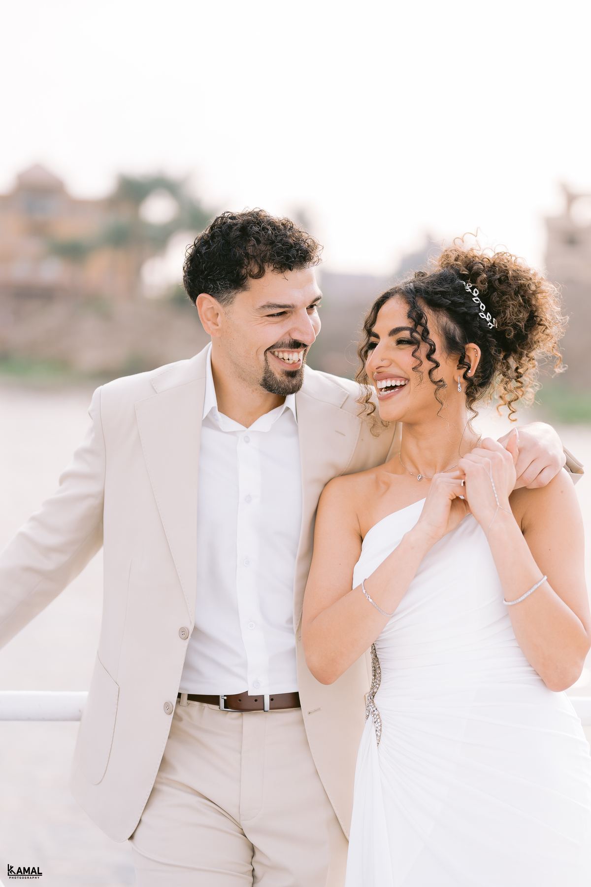 Anas and Salma laughing together by the water